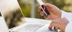 businessman with cellphone and laptop at morning